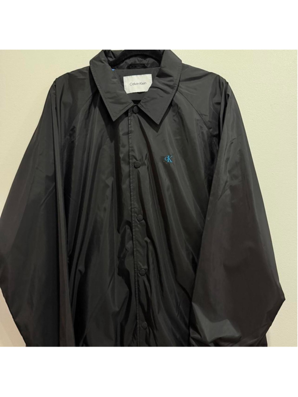 Stylish black Calvin Klein jacket with blue CK logo detail